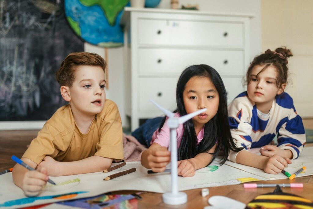 Happy friends drawing together in a room.